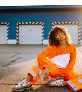 African American woman - dancer dancing in street at sunset. Sport, dancing, urban culture concept.
